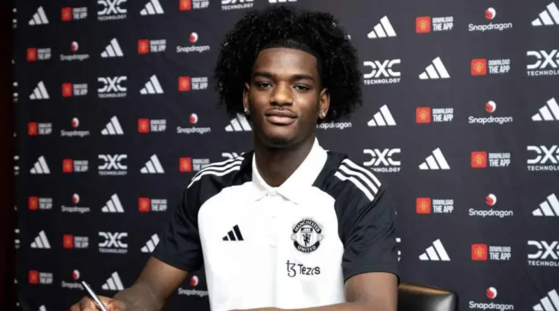 Ayden Heaven poses in a Manchester United shirt after completing his transfer from Arsenal. The defender has signed until 2029.